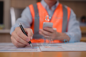 Engineer wearing safety vest using pen check data sheet with virtual modern reduce co2 emission in Concept of renewable energy, Industry 4.0, digital engineering, and sustainable technology.