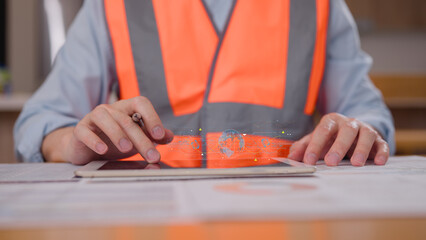 Engineer wearing safety vest using tablet and pen with virtual modern reduce co2 emission concept with icons global warming emissions carbon footprint climate change to limit global warming energy