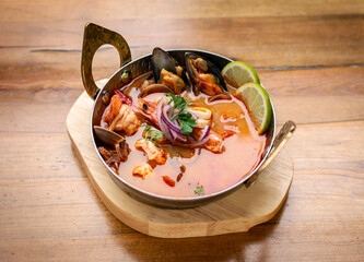 mixed seafood tom yum thai curry soup indoors ina a phuket thailand restaurant