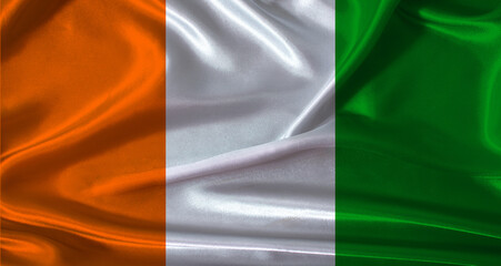 National flag of Ivory Coast with cloth texture. Ivory Coast flag with realistic texture background © IHERPHOTO