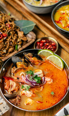 mixed seafood tom yum thai curry soup indoors ina a phuket thailand restaurant