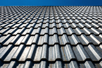 Modern roof tiles pattern under daylight, representing home construction, building material, property protection, architecture design and residential exterior concept.