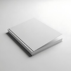 A blurry grayscale image of a closed book on a plain surface