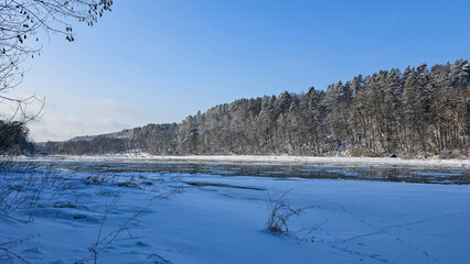 Winter River Serenity: Ice Floes and Snowy Forest