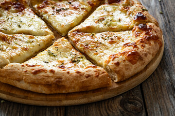 Pizza Bianca white pizza with oregano on wooden table
