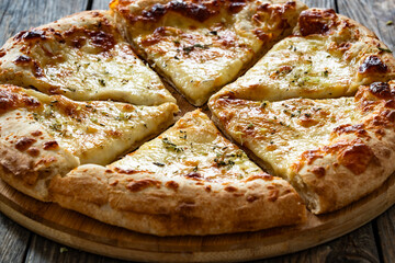 Pizza Bianca white pizza with oregano on wooden table