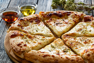 Pizza Bianca white pizza with oregano on wooden table