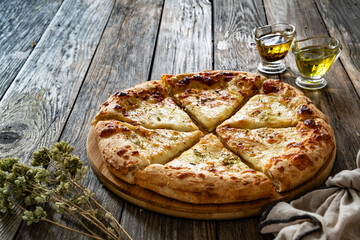Pizza Bianca white pizza with oregano on wooden table	