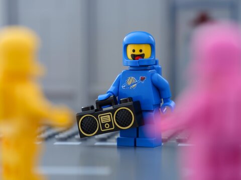 Tambov, Russian Federation - May 30, 2025 Blue Lego astronaut minifigure holding a boombox standing next to two other Lego cosmonauts