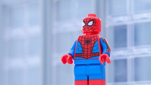 Tambov, Russian Federation - January 24, 2025 Lego Spiderman minifigure standing in front of an office building. Close-up