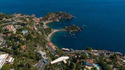 Aerial view of Isola Bella, in Sicily, Italy. It is an Italian tidal island located in the Ionian Sea, near Taormina. It is a nature reserve in the Mediterranean Sea. It is a sunny summer morning.