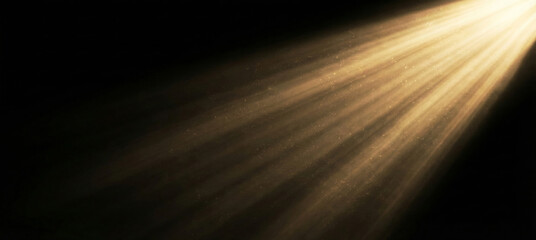 Golden spotlight beam shining from top right with floating dust particles on black background