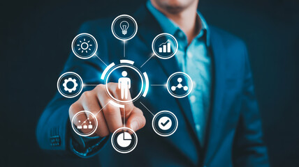Businessman's hand touching a digital interface with icons representing human resources and business processes