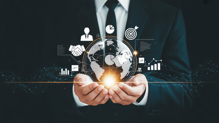 Businessman's hands cradle a glowing digital Earth surrounded by business icons, data visualizations, and network connections
