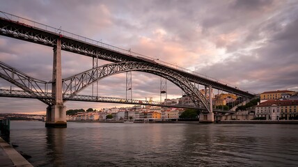 Fototapeta premium Historic Steel Arch Bridge Urban River City Sunset Skyline Photo