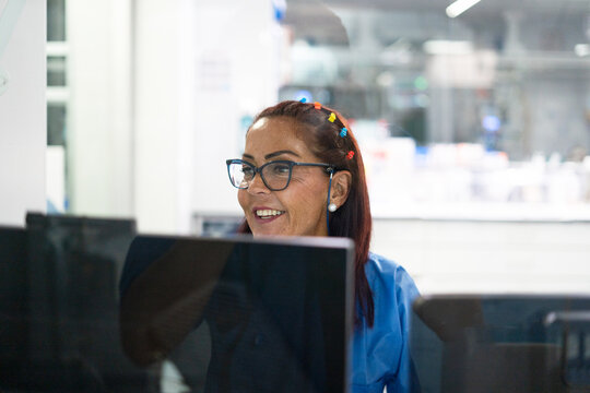 Experienced woman working on computer in office