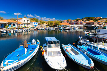 Obraz premium The charming Mediterranean port village of Molivos (Mithymna) on the Greek island of Lesvos on a sunny day, wallpaper or background for your project