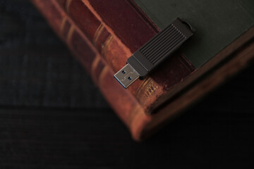 A collection of antique books on a dark wooden table. Archival book research, education, and...