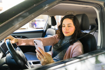 Woman distracted while driving, looking at phone and texting, unsafe behavior causing road hazard