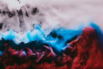 Abstract colorful smoke background. Moving flow of blue, red, white paints, fluid art
