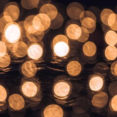 Abstract orange bokeh lights shimmering on dark water surface with soft glow and hazy atmosphere, out of focus background
