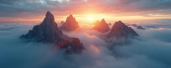 Dramatic photo of mountain peaks emerging from clouds during sunrise. Scenic landscape view features towering rock formations against a colorful sky. Nature scenery with gold sunlight.