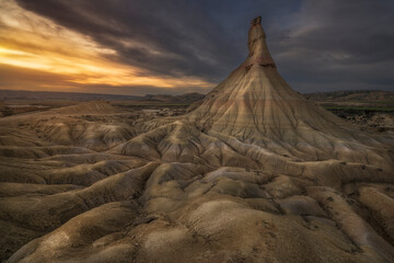 Castildetierra rock formation at sunset in Bardenas Reales desert landscape under dramatic sky