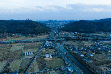 Fototapeta premium Sunset over the residential cityscape and mountains of Akaiwa, Okayama, Japan