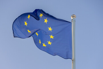 European union flag waving on flagpole against clear sky
