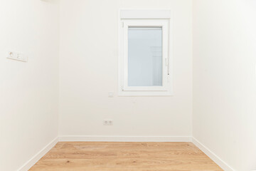 Image of an unoccupied room where the walls sport a freshly applied pastel blue, contrasting with...