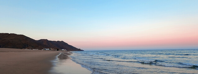 Sunset on Al Sifah beach not far from Muscat, Oman. Web banner with copy space