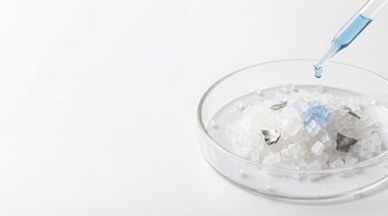 Laboratory Petri Dish with Lithium Salt Crystals and Blue Chemical Solution Drop - Battery Material Research
