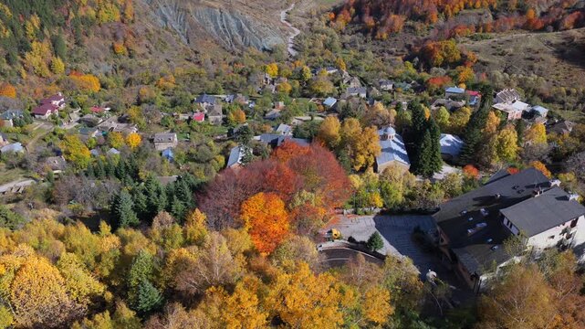 A sweeping autumn aerial video of Dardh&euml;, showcasing its hillside village framed by steep forested mountains and rich seasonal colours.