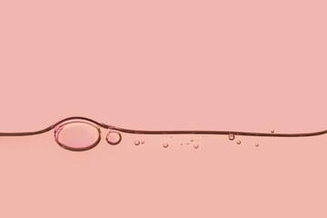 Beauty skin care product swatch sample. Liquid red skin care gel or serum texture smudge abstract background