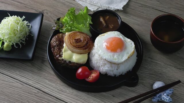 Loco Moco, a traditional Hawaiian dish of teriyaki flavored ground beef patty and a fried egg on a bed of rice, smothered in gravy