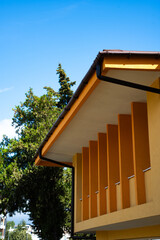 modern design of a building in Bulgaria. The structure features bright colors and unique angles, surrounded by trees and a clear blue sky, ideal for sightseeing