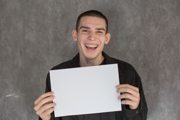 Young Man Holding Blank White Sign for Your Message