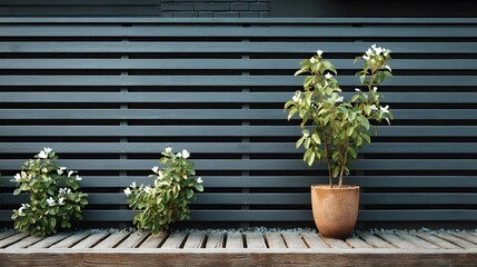 Modern dark grey horizontal slat fence made of sleek aluminum or composite material used as outdoor privacy screen near blurred garden.