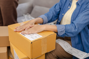 Small business, partnership, warehouse store, worker packing cardboard boxes and preparing customer orders at small warehouse, people at work handling ecommerce process, teamwork in startup business