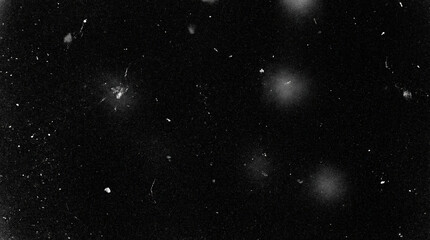 Moody vintage film grain and scattered dust specks on deep black background evoke a nostalgic haunting night sky or abstract cosmic texture