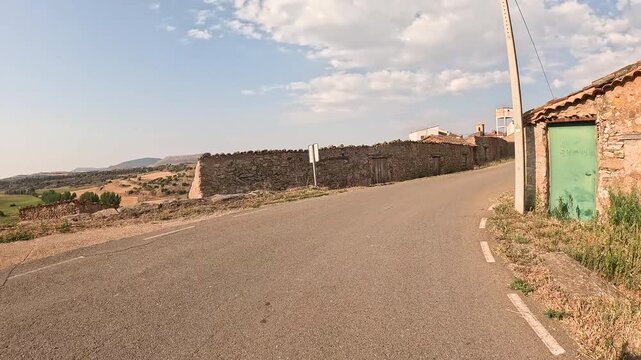 paved road entering Reznos village, comarca of Campo de Gomara, province of Soria, Castile and Leon, Spain