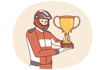 Fototapeta premium Man racer with golden cup for winning tournament rejoices at receiving championship title in competition. Guy driver, participant in extreme races on cars, demonstrates trophy of racer