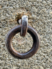 Old rusty metal ring bolted to the concrete wall in Lisbon, Portugal.