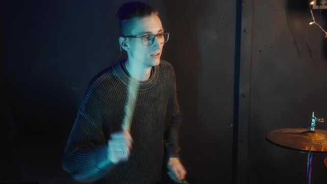 white drummer focused technique session in moody studio