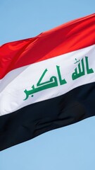 Iraq Flag Waving Under Clear Sky