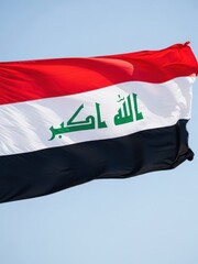 Iraq Flag Waving Under Clear Sky