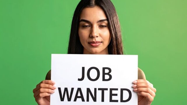Young woman holding a sign that says job wanted against green background.