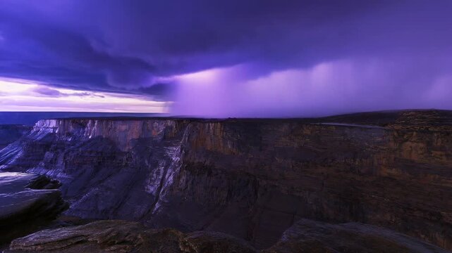 Dramatic storm clouds unleash rain over majestic canyon landscape