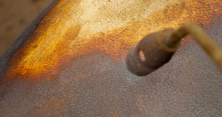 Witness the traditional process of slaughtering a domestic pig in a rural village with blue flame gas burner. This method produces flavorful homemade pork for personal use.