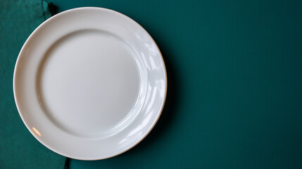 A single white ceramic plate displayed on a solid dark green background, soft shadows for depth, clean minimal aesthetic